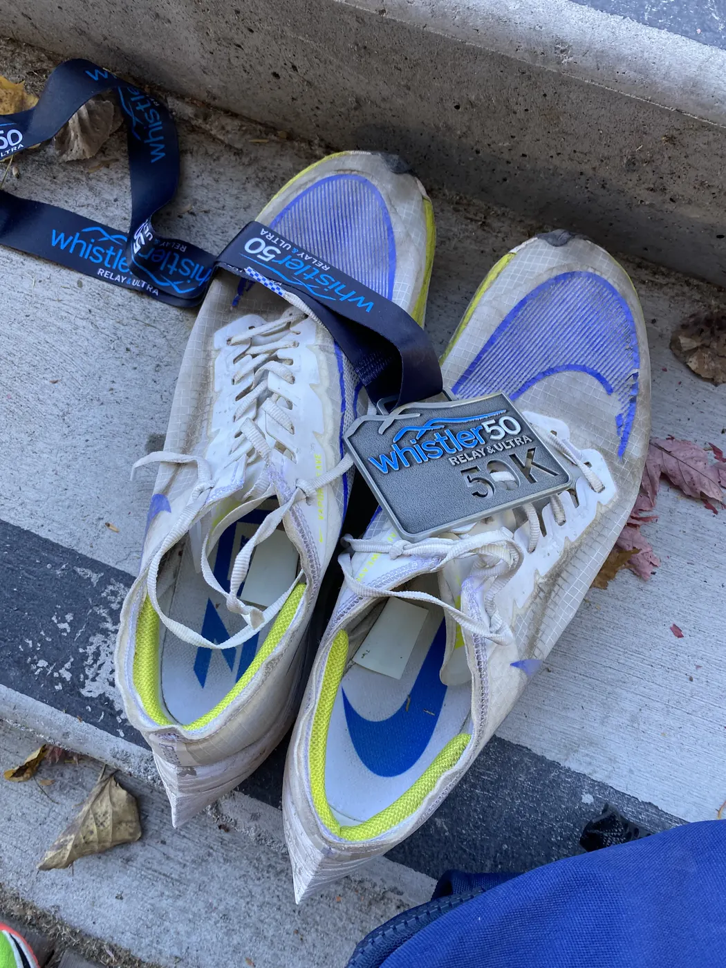 Race medals and running shoes after the Whistler 50K